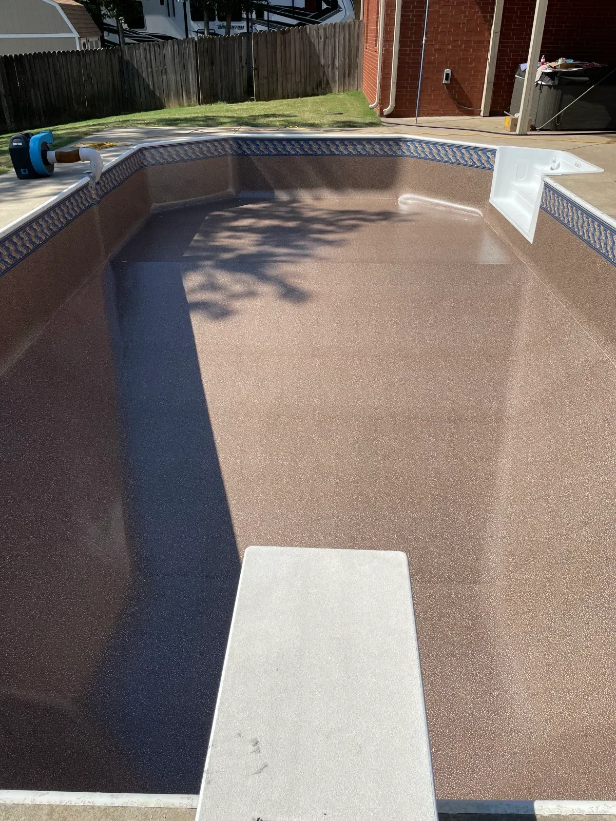 Pool deck resurfacing with new textured concrete coating and repaired pool shell edge
